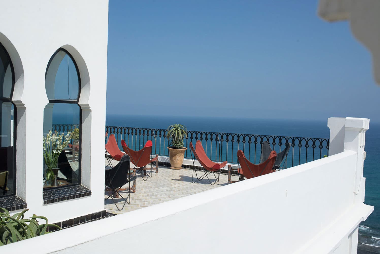 A picturesque terrace at Hotel Nord Pinus Tanger, offering a breathtaking view of the Atlantic Ocean.