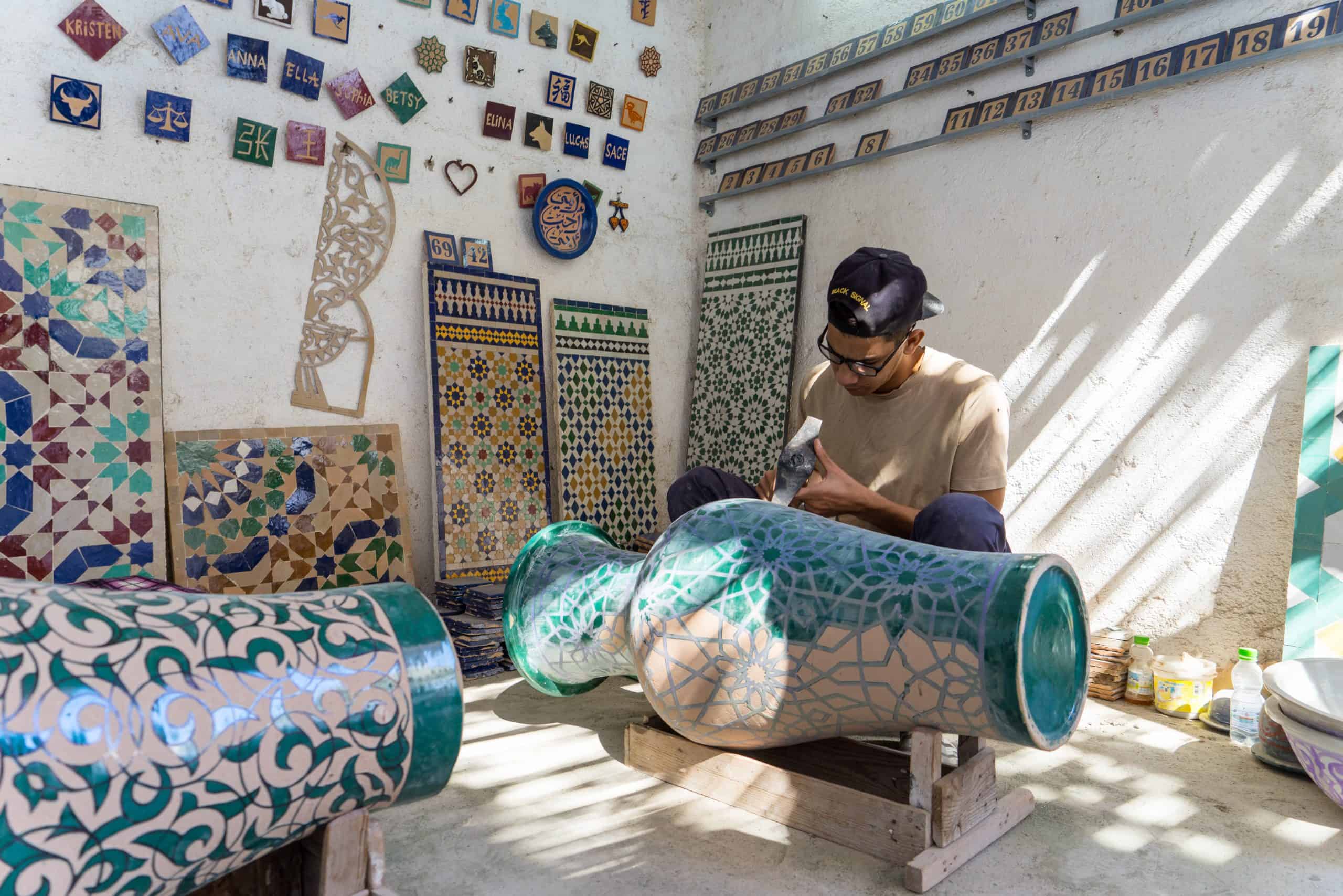 A dedicated artisan working on an intricately designed ceramic piece.