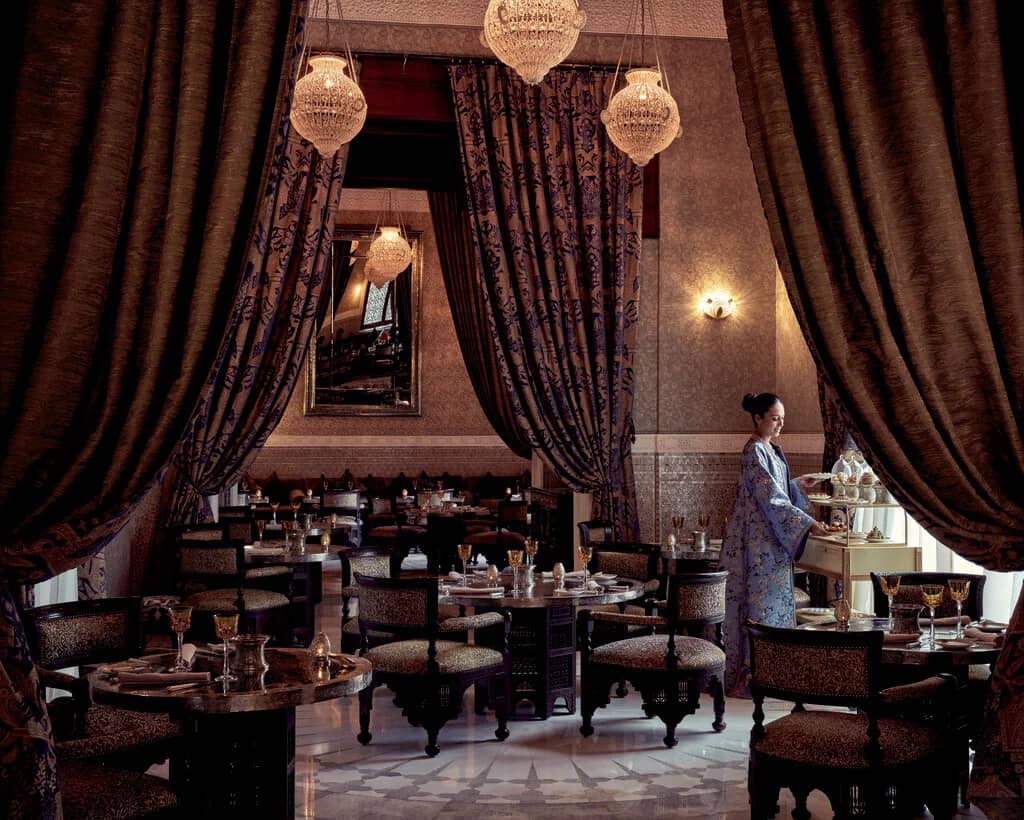 La Grande Table Marocaine, the Michelin-starred restaurant at Royal Mansour, exudes opulence with its luxurious drapery, ornate decor, and crystal chandeliers.