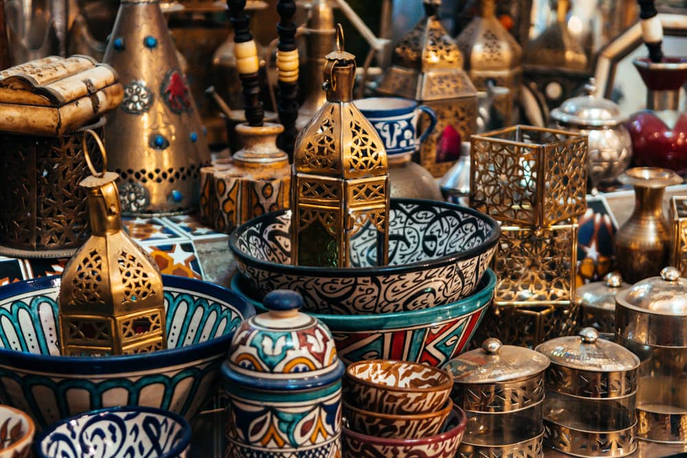 A vibrant collection of artisanal products, featuring intricately designed lanterns, colorful pottery, and other handcrafted items.